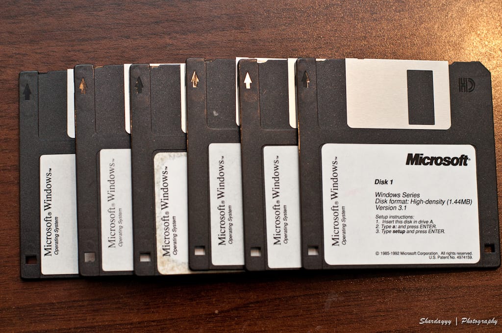 Microsoft Windows 3.1 installation disks: six 3.5" floppy disks arrayed like playing cards in a row